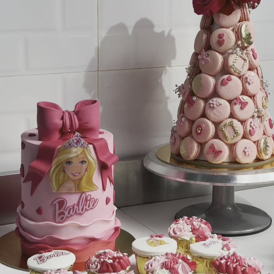 Experience the enchantment of our Barbie Cake Bundle with a captivating display of beautifully crafted cakes adorned with Barbie-themed decorations, ideal for adding magic to any celebration or event.
